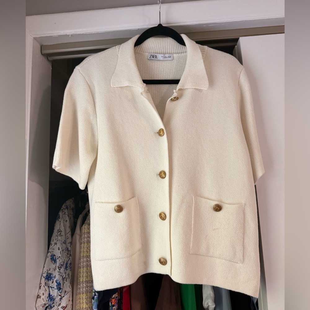 Beautiful cream, white knit, short sleeve shirt with gold buttons. SIZE L